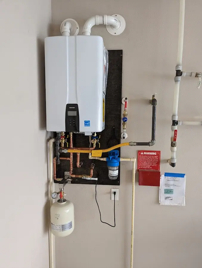 Professional plumber installing copper piping in a Bridgetown home